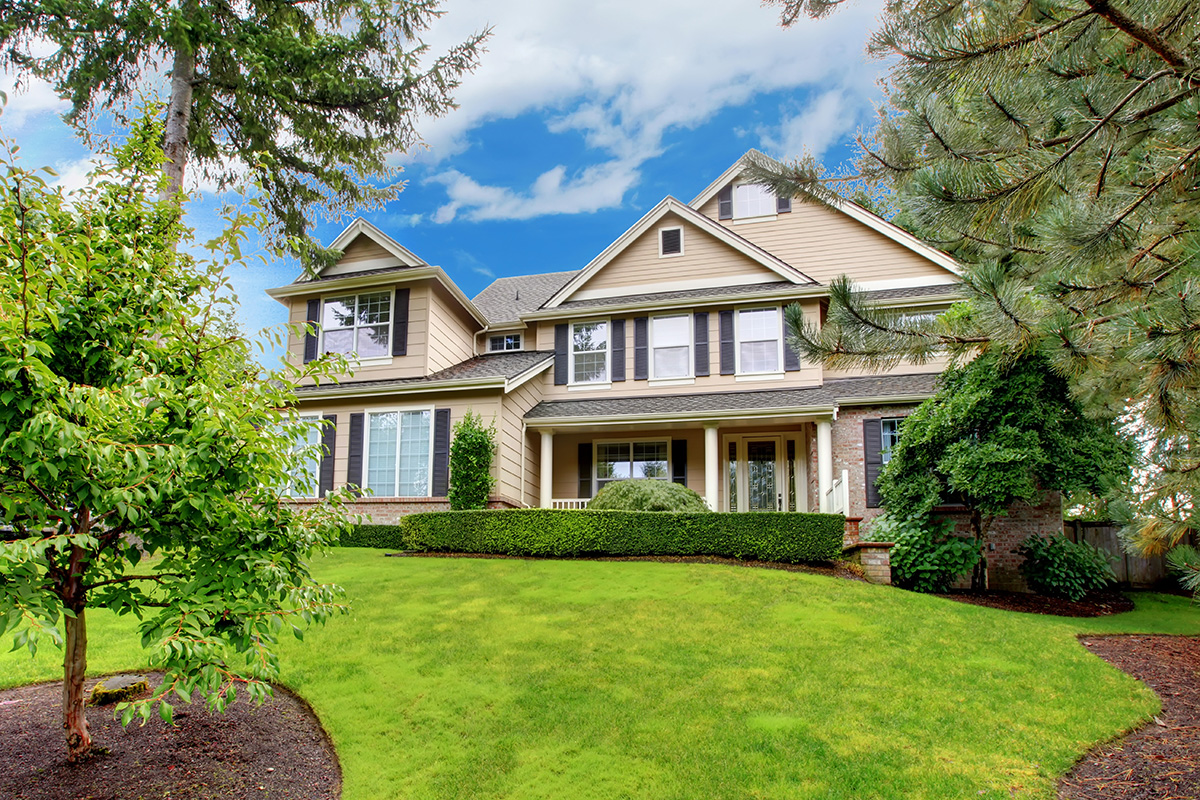 Large beautiful home with green grass